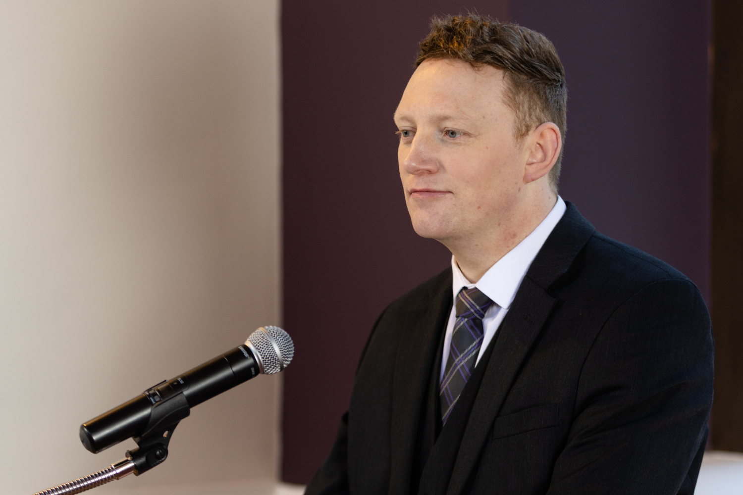 An officiant making a speech at a podium