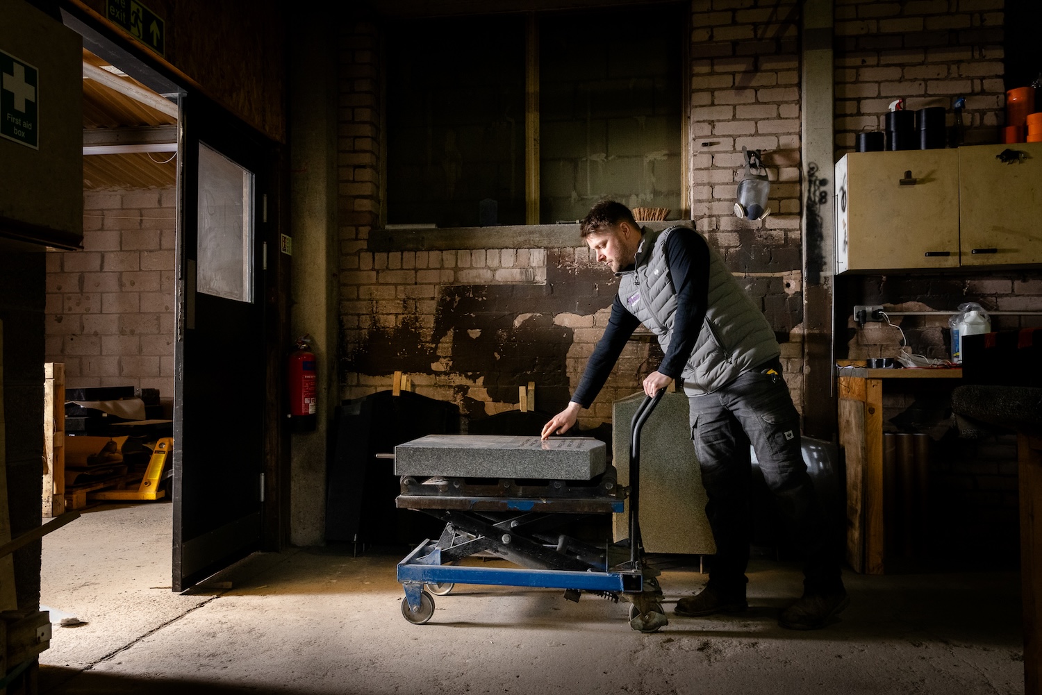 A man transporting an engraved headstone